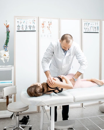 a2z chiropractic male doctor performs a physical exam on a woman