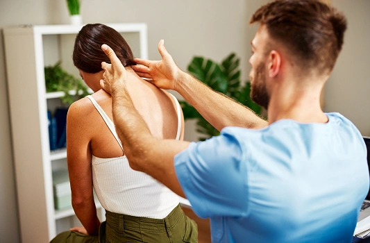 a2z chiropractic woman conducts a back examination on a man